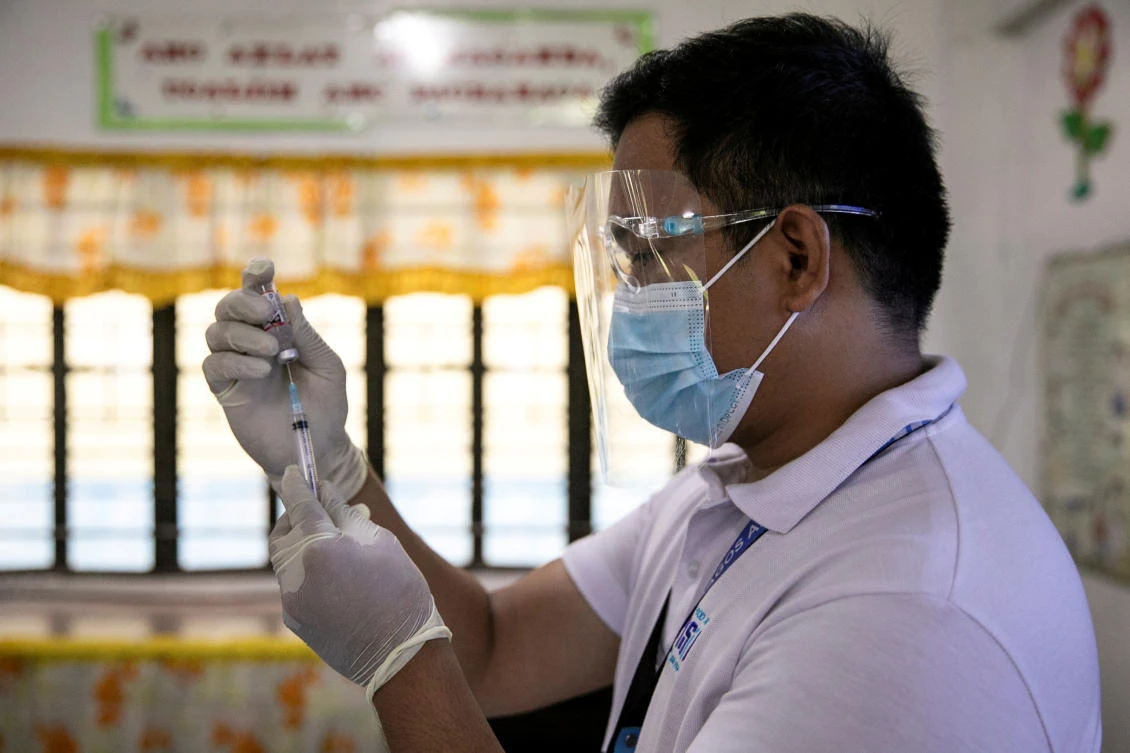 A health worker participates in a simulation for COVID-19 vaccination in preparation for its arrival at a vaccination command center in the Philippines on Feb. 16, 2021. (Reuters)