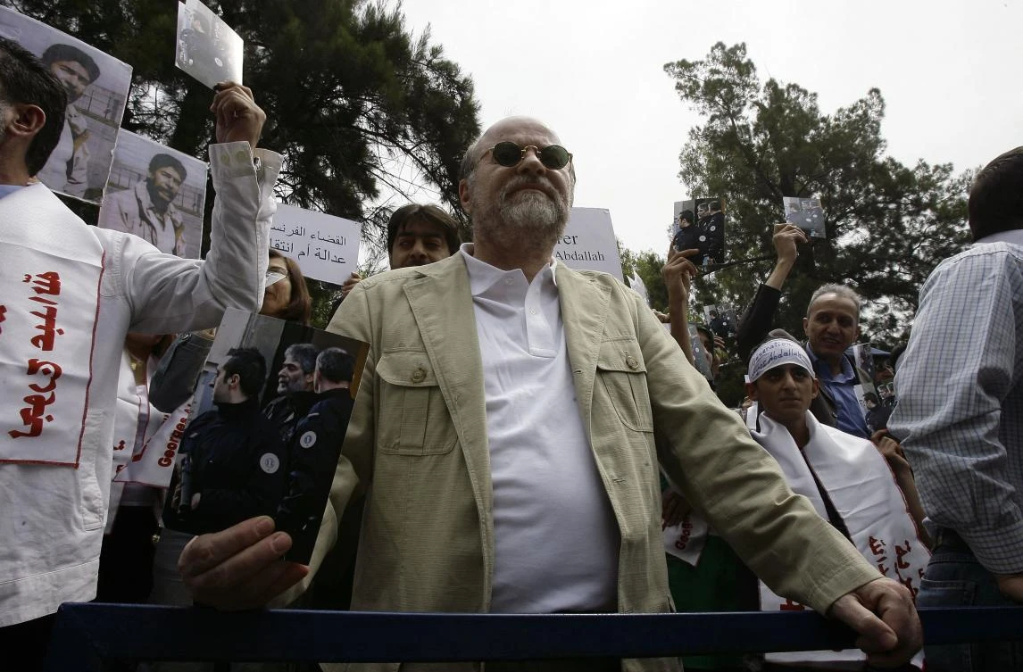 A file photo taken on April 30, 2010, shows Anis Naccache holding a picture of Georges Ibrahim Abdallah during a demonstration outside the French embassy in the capital Beirut. (AFP)