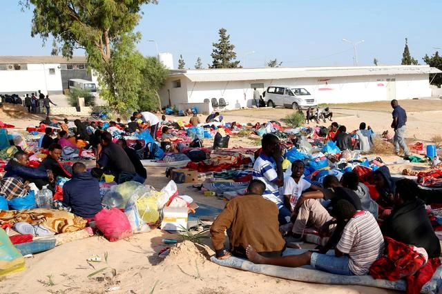 Migrants are seen with their belongings in the yard of a detention centre for mainly African migrants, hit by an air strike, in the Tajoura suburb of Tripoli, Libya July 3, 2019. (Reuters)