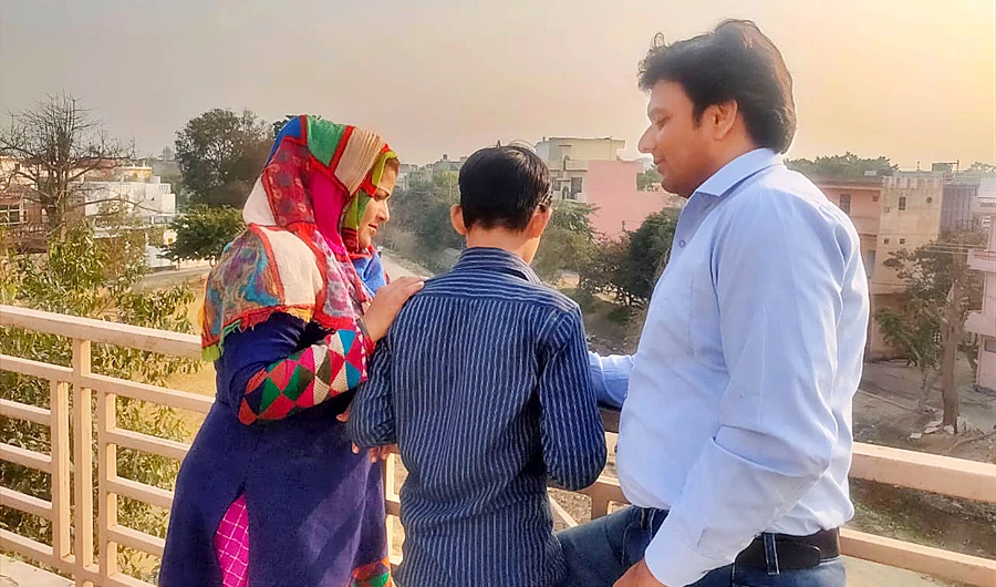 Shabnam Ali’s child, Mohammad Taj, 12, with his adoptive parents at their house in the Bulandshahar district of Uttar Pradesh on Monday. (Photo credit: Usman Saifi)