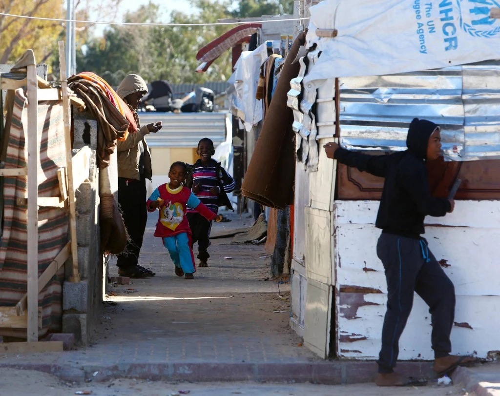 Above, children play at a refugee camp in Tripoli that hosts internally displaced people. (AFP file photo)