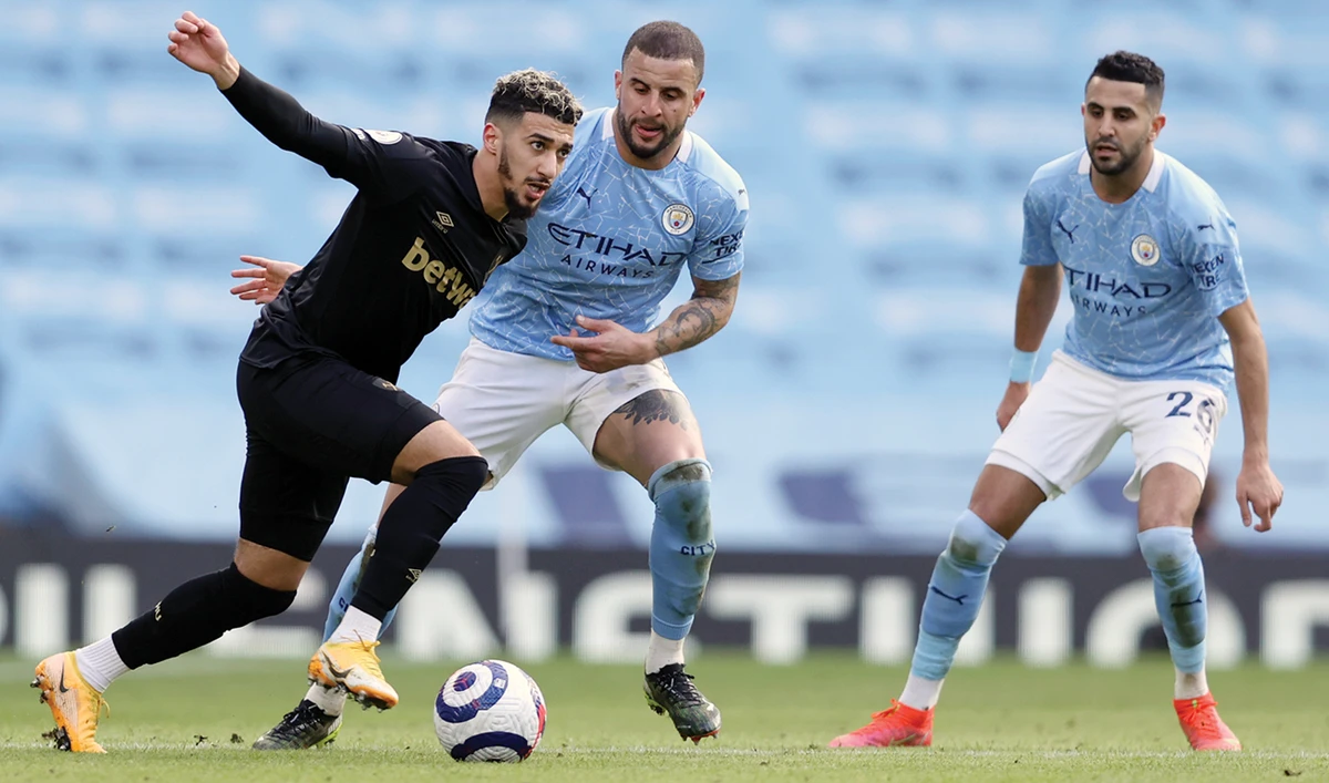 West Ham’s Said Banrahma duels for the ball with Manchester City’s Kyle Walker during Saturday’s Premier League match at the Etihad Stadium in England. (AP)