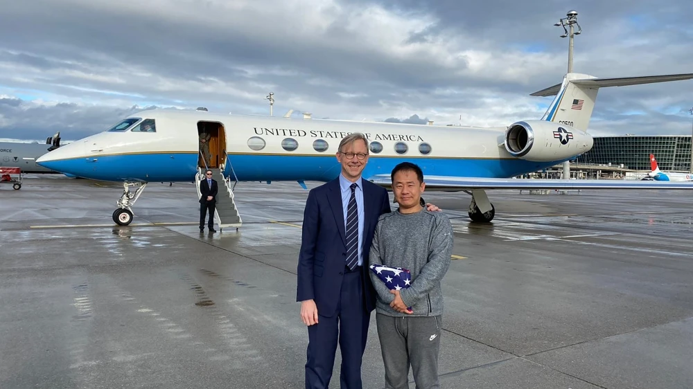 Xiyue Wang, right, stands with Brian Hook, US special representative for Iran, in Zurich. (AP Photo)