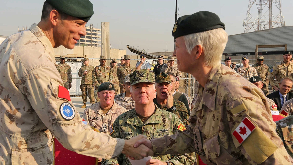 Jennie Carignan, the incoming commander of NATO’s Iraq mission, is greeted by outgoing commander Dany Fortin, Baghdad, Nov. 26, 2019. (Getty Images)