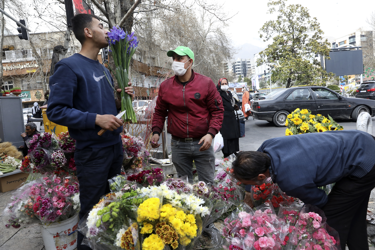 Flower sellers arrange their flowers ahead of the Persian New Year, or Nowruz, meaning "New Day." in northern Tajrish Square, Tehran, Iran, Monday, March 15, 2021. (AP)