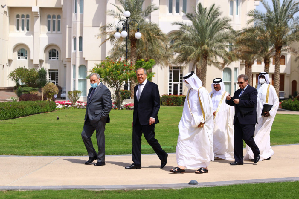 Russian Foreign Minister Sergei Lavrov walks to meet with Qatar's Emir Sheikh Tamim bin Hamad al-Thani in Doha on March 11, 2021. (Russian Foreign Ministry handout via AFP)