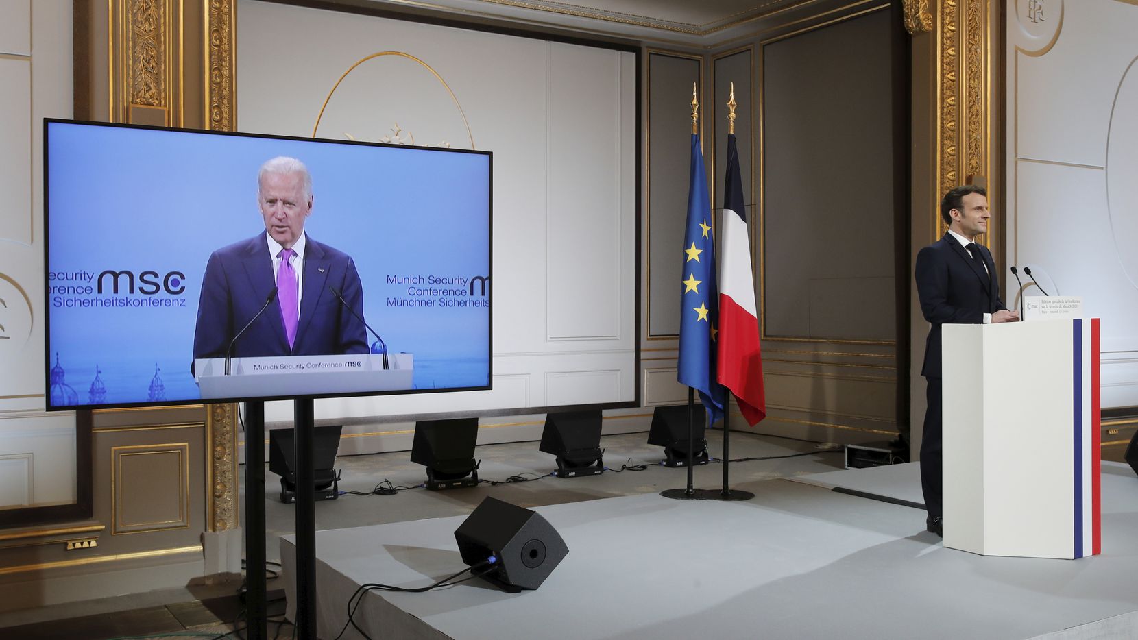 Emmanuel Macron watches Joe Biden address the 2021 Munich Security Conference at the Elysee Palace in Paris, Feb. 19, 2021. (AP Photo)