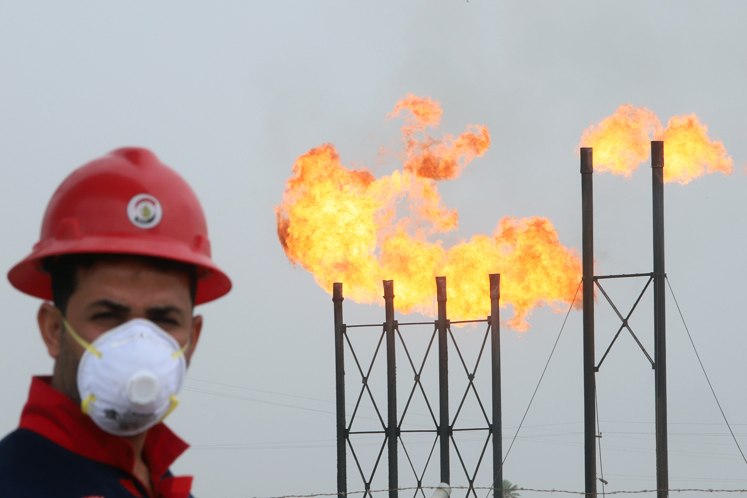 Flames emerge from flare stacks at Nahr Bin Umar oil field, north of Basra, Iraq, March 15, 2020. (Reuters)