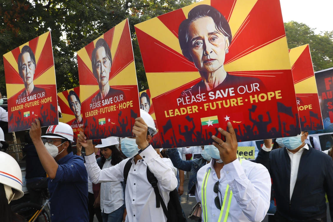 Engineers hold posters with an image of deposed Myanmar leader Aung San Suu Kyi as they stage an anti-coup protest march in Mandalay, Myanmar, Monday, Feb. 15, 2021. (AP)