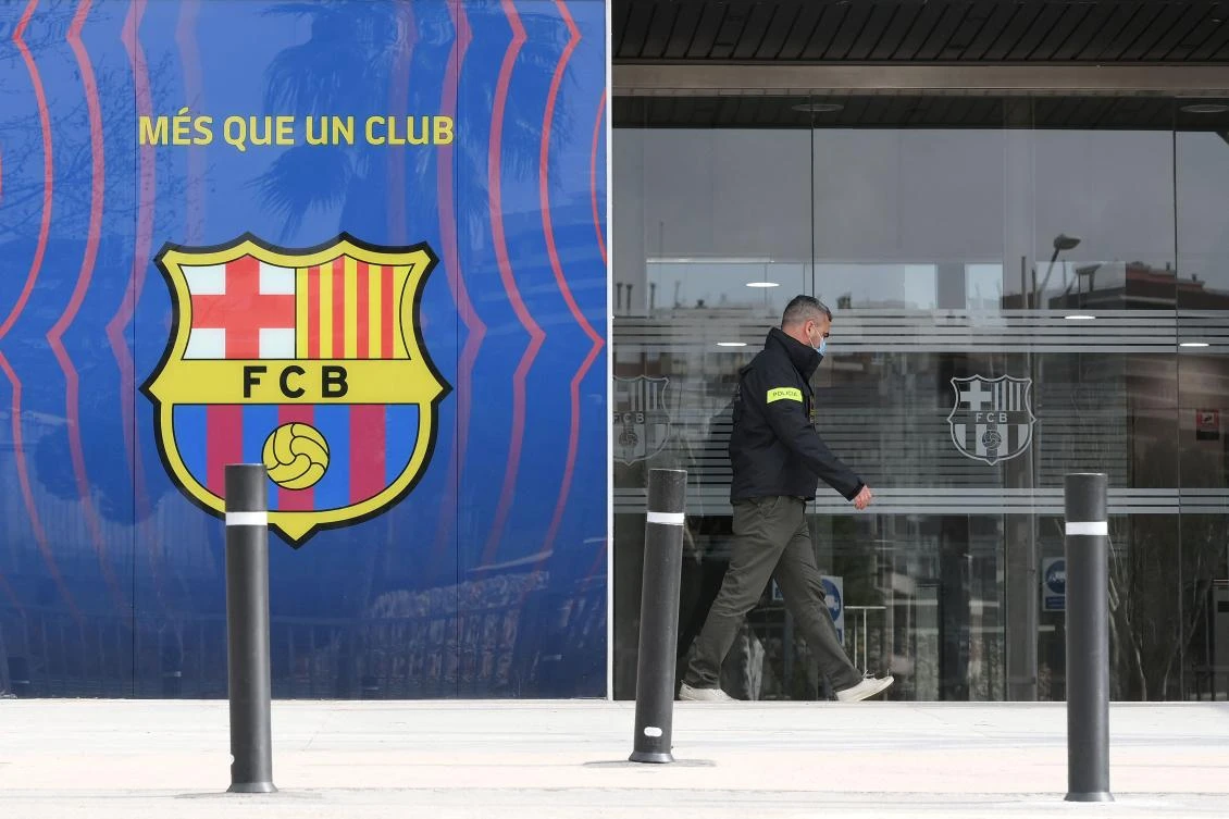A policeman leaves the offices of Barcelona Football Club on March 01, 2021 in Barcelona during a police operation inside the building. (AFP)