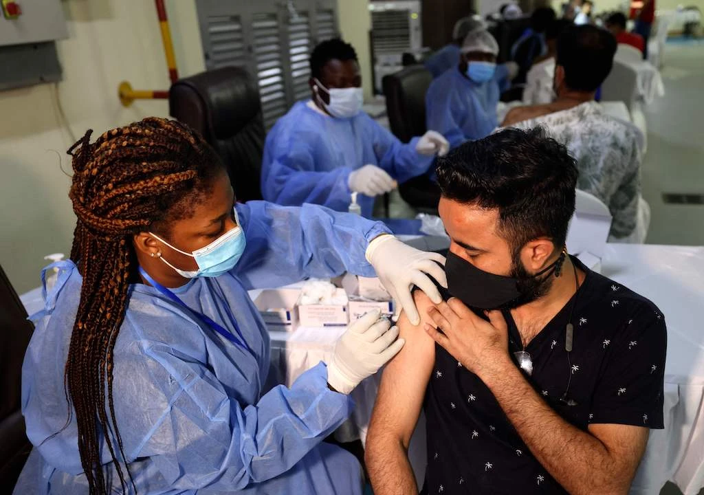 A healthcare worker administers a shot of China's Sinopharm COVID-19 vaccine to a man at the Guru Nanak Darbar Gurudwara (Sikh temple) in Dubai on February 28, 2021. (AFP)