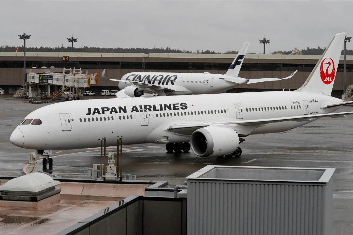 A plane believed to carry US citizens Michael Taylor and his son Peter Taylor arrive at Narita airport following extradition to Japanese prosecutors, in Chiba, Japan, March 2, 2021. (Reuters)