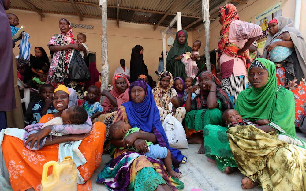 Internally displaced Somali mothers and children wait for medicine at a Save the Children UK clinic at their camp in the Hodan district of Somalia’s capital Mogadishu, Nov. 21, 2012. (Reuters)