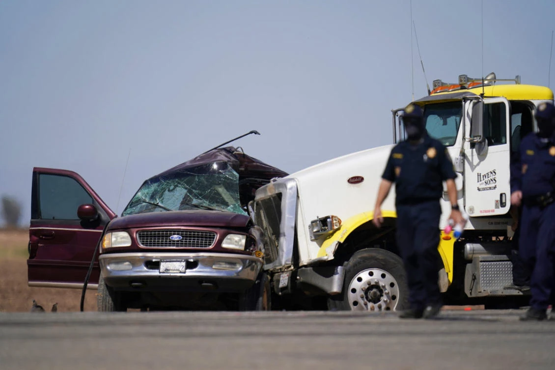 Law enforcement officers work at the scene of a deadly crash in Holtville, California, on March 2, 2021. (AP Photo/Gregory Bull)