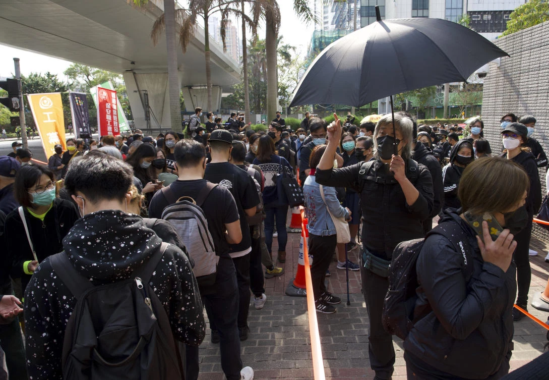 Supporters queue up outside a court to try to get in for a hearing in Hong Kong on March 1, 2021. (AP)