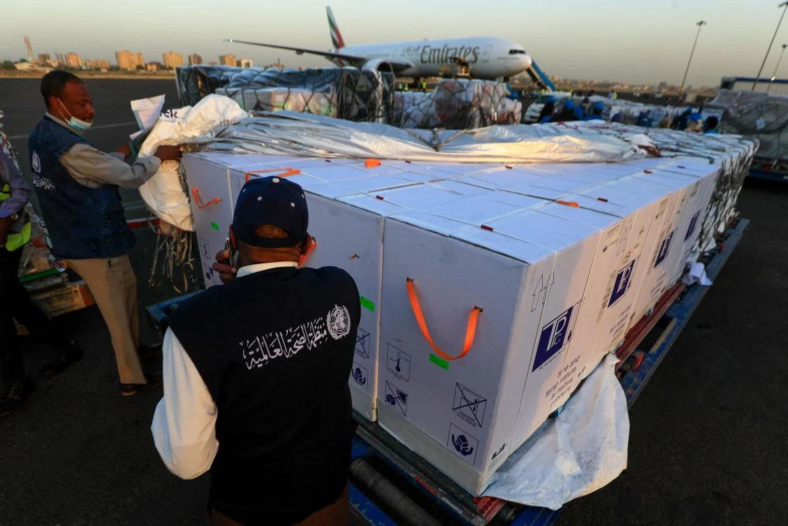 An employee of the WHO supervises the arrival of the first batch of coronavirus vaccines, at Khartoum airport on March 3, 2121. (AFP)