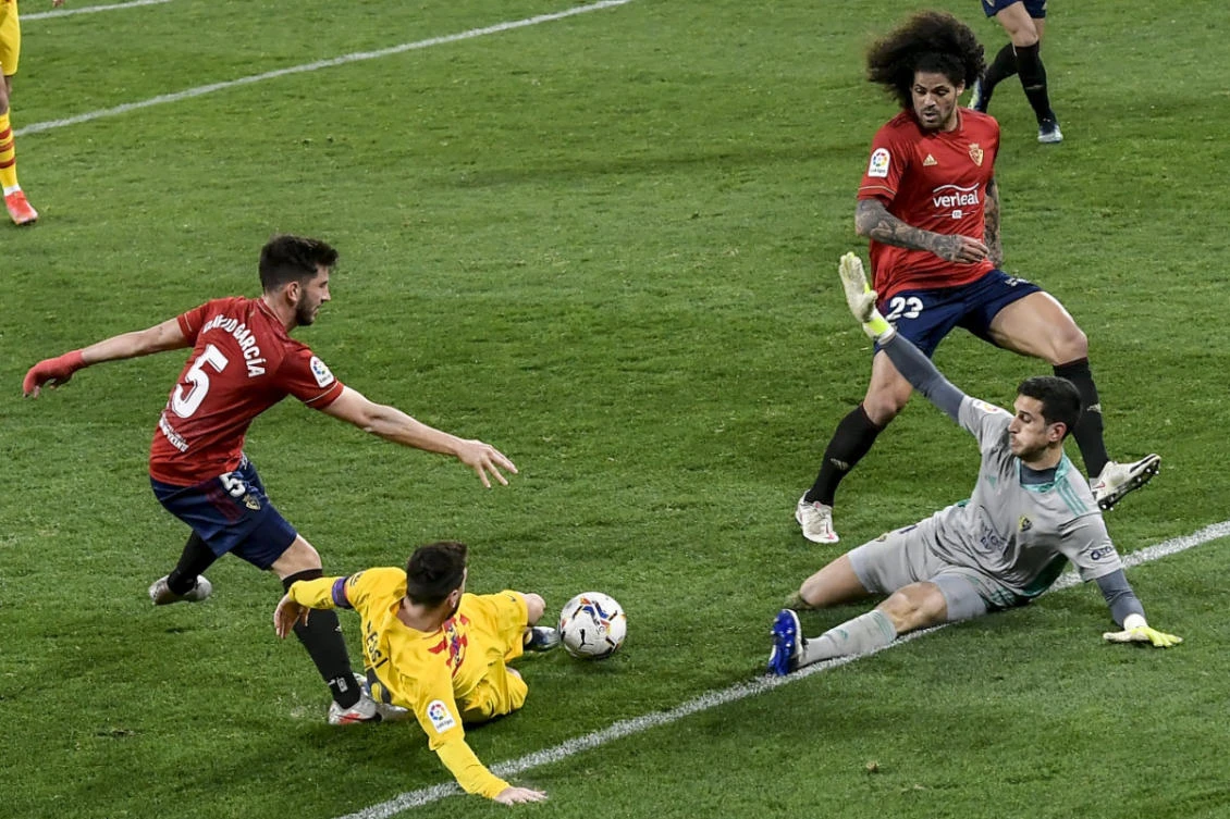 Barcelona's Lionel Messi, second left, tries to score during the Spanish La Liga soccer match between Osasuna and FC Barcelona at El Sadar stadium in Pamplona, Spain, on March 6, 2021. (AP Photo/Alvaro Barrientos)