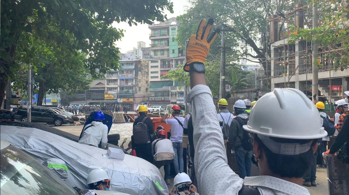 Protesters wearing helmets stand behind a barricade in Sanchaung, Yangon, Myanmar on March 3, 2021, in this still image from a video obtained by Reuters. (Supplied photo via Reuters)