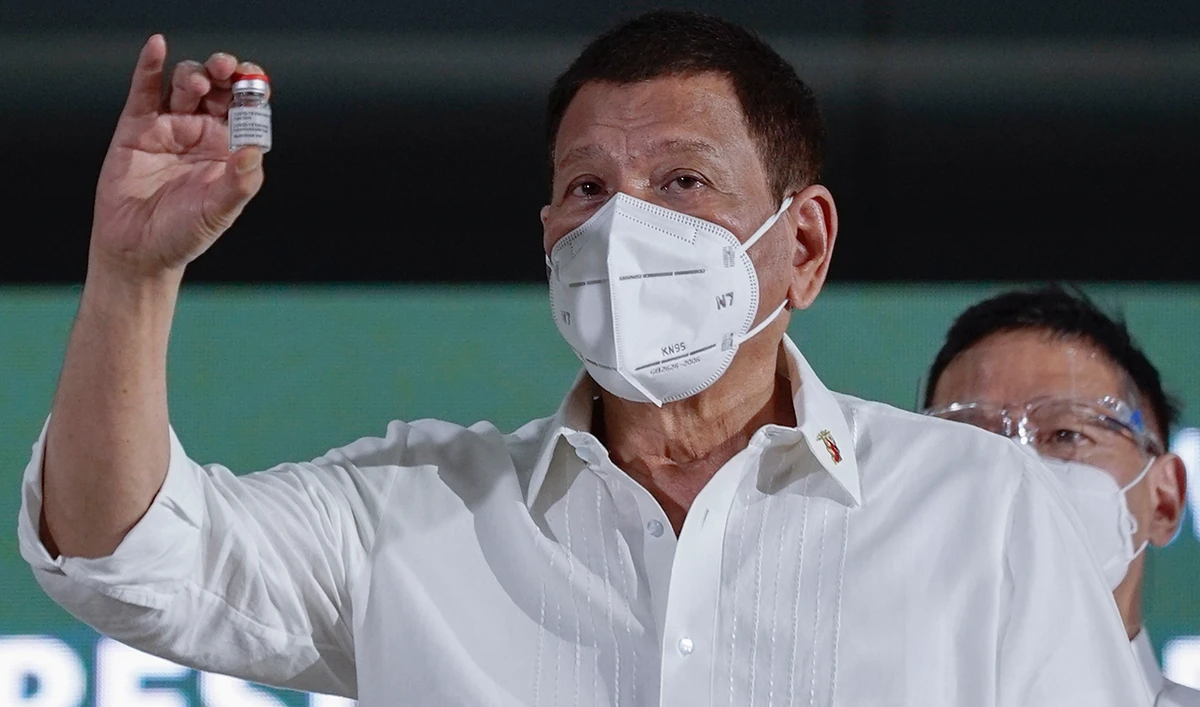 Philippine President Rodrigo Duterte shows a vial containing the AstraZeneca vaccine as it arrives at Villamor Air Base in Metro Manila, Philippines on Thursday March 4, 2021. (AP)