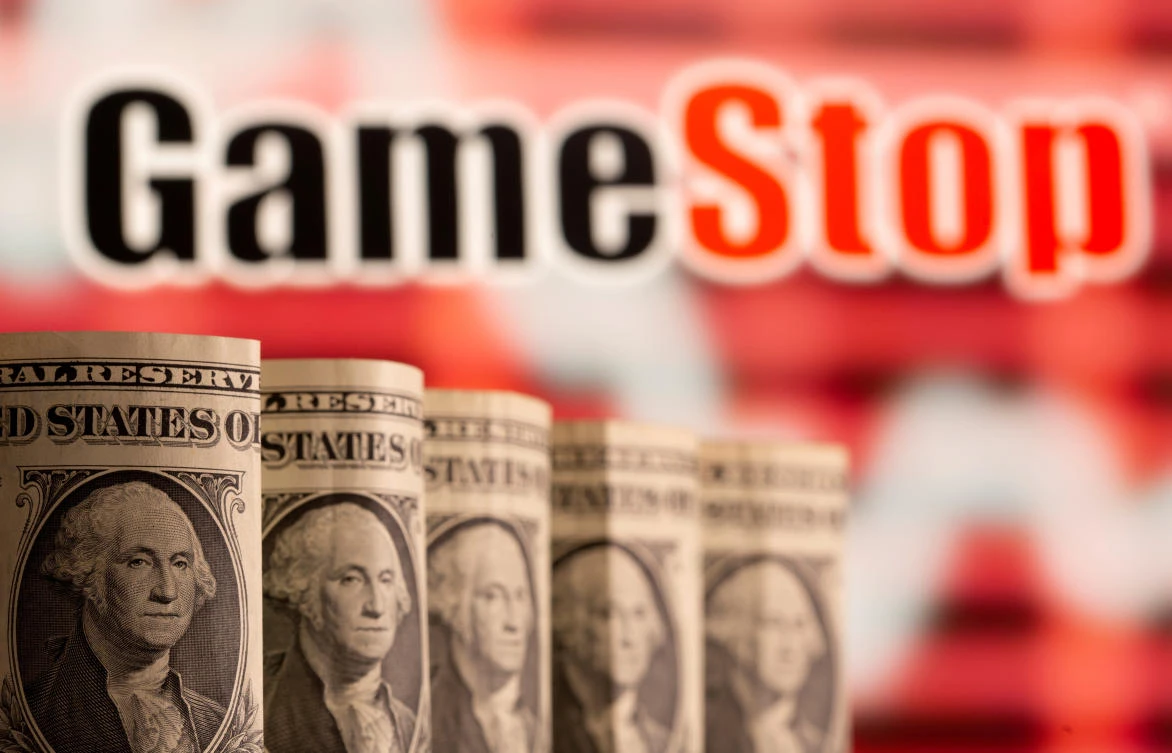 US one dollar banknotes are seen in front of displayed GameStop logo in this illustration taken February 8, 2021. (Reuters)