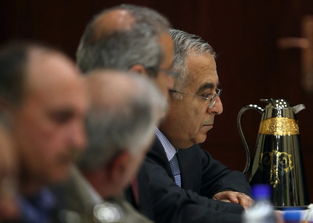 Former prime minister Salam Fayyad, right, called for a national effort to strengthen Palestinian steadfastness with authority and justice. (AFP file photo)