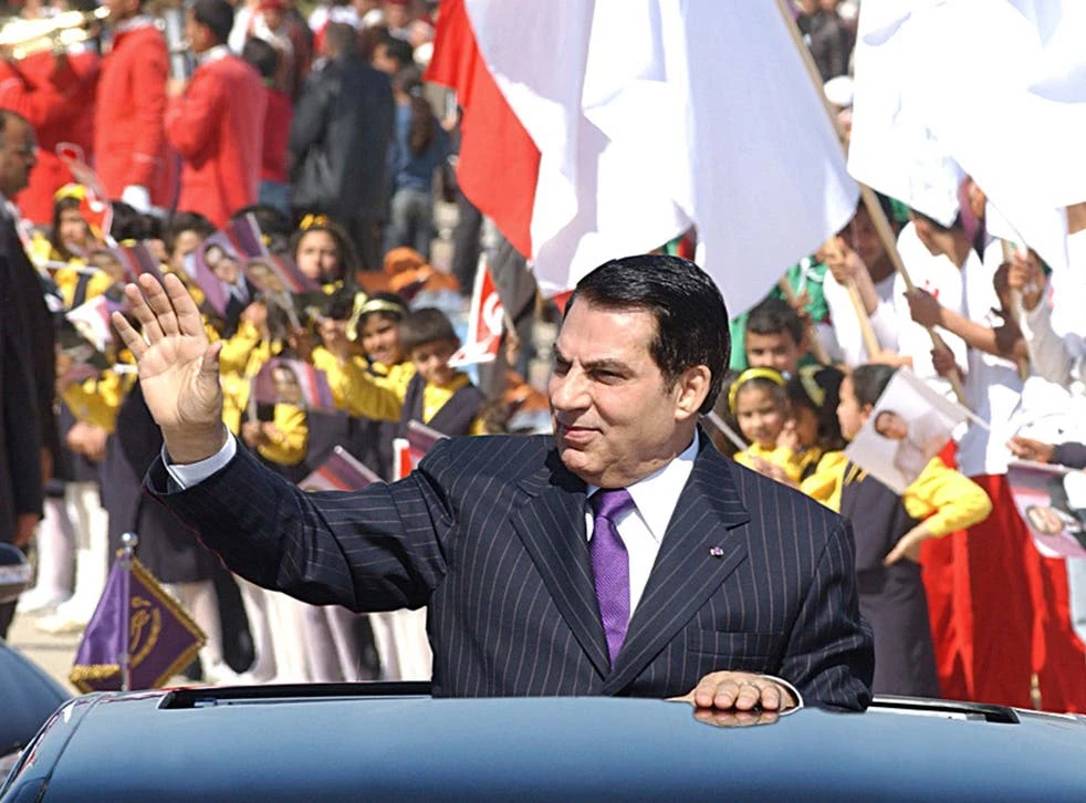 Former Tunisian president Zine El Abidine Ben Ali waves to the crowd at Rades stadium where he delivered his speech on the 50th anniversary of independence of Tunisia from France. (File/AFP/Getty)