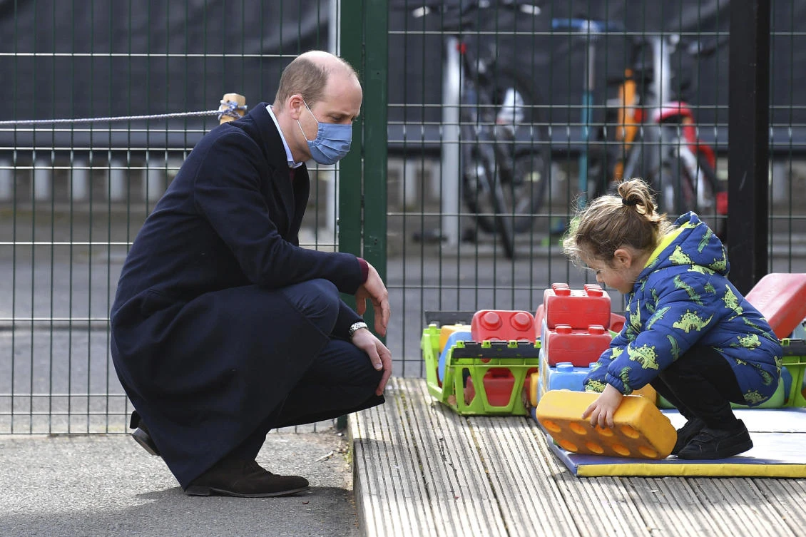 Britain's Prince William watches a child in the playground during a visit with Kate, Duchess of Cambridge to School21, a school in east London, Thursday March 11, 2021. (AP)