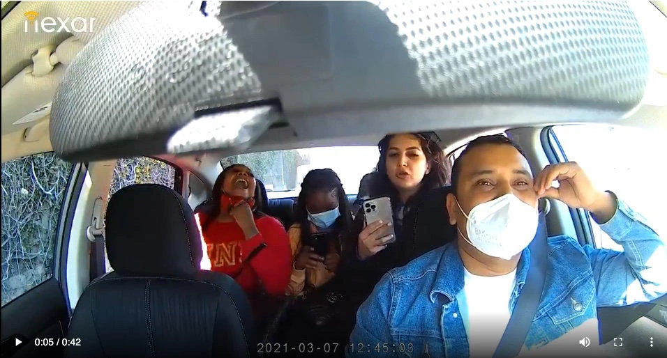 Screen grab from a video shared on Twitter showing an Uber driver being coughed up and harassed by three women in the US.