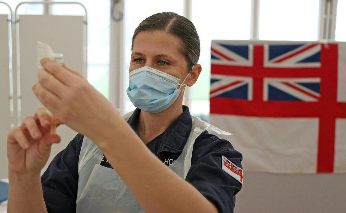 A Royal Navy medic prepares syringes ahead of giving injections of the Oxford/AstraZeneca Covid-19 vaccine in Bath, southwest England. (AFP)