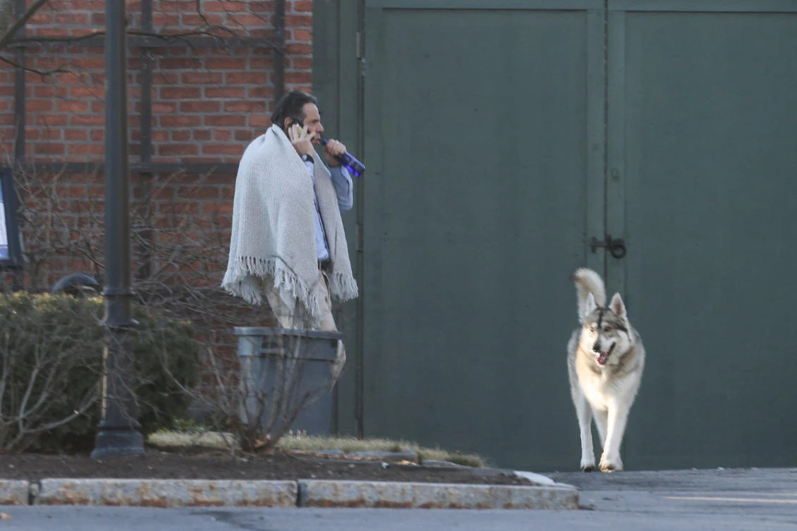 An increasingly isolated New York Governor Andrew Cuomo walks on the grounds of the Governor's Mansion in Albany, New York, on March 12, 2021 following allegations that he had sexually harassed young women. (REUTERS/Angus Mordant)
