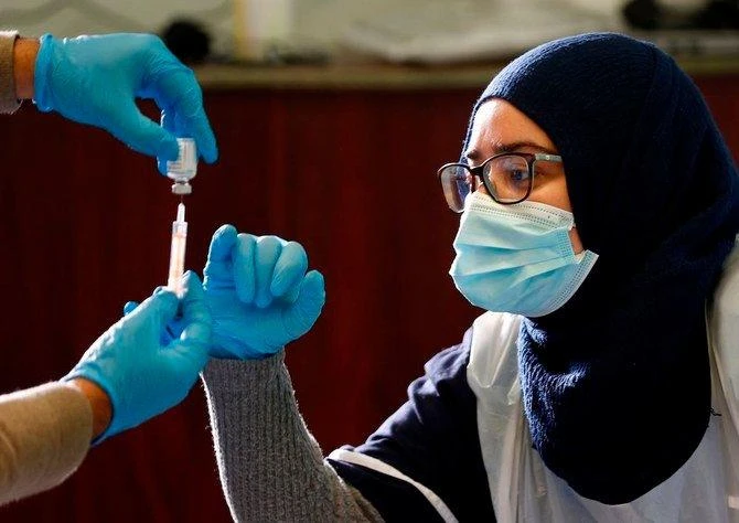 A COVID-19 vaccine is prepared at the Al-Abbas Islamic Centre in Birmingham, central England. (File/AFP)