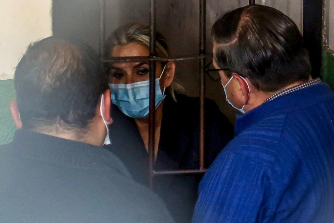 Former interim Bolivia's President Jeannine Anez speaks with her lawyers in a prison cell of the Special Force for the Fight Against Crime (FELCC) after being arrested in La Paz, on March 13, 2021. (AFP)