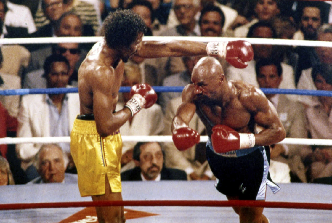 Marvin Hagler, right, pictured fighting Thomas Hearns in April 1985, died Saturday, March 13, 2021. He was 66. (File/AP)
