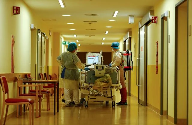 Members of the medical staff in protective suits transport a patient suffering from the coronavirus disease (COVID-19) in the Intensive Care Unit (ICU) at Havelhoehe community hospital in Berlin, Germany. (Reuters)
