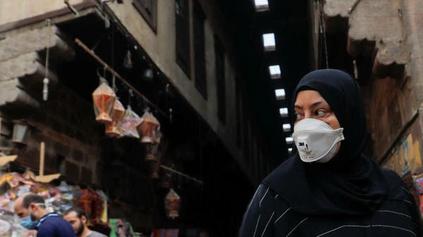 A woman wearing a protective face mask walks down Al Khayamia street in old Cairo, Egypt April 16, 2020. (Reuters)