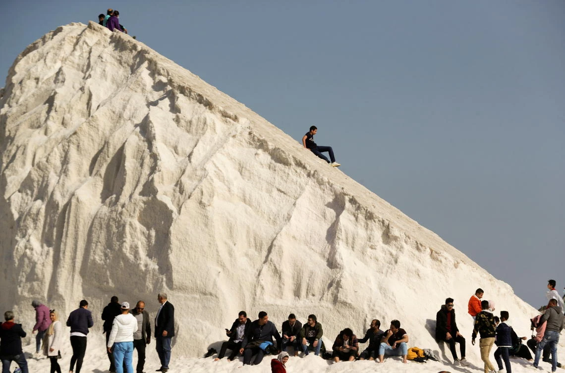 People visit the small salt hills in the canal city of Port Fouad. (Reuters)