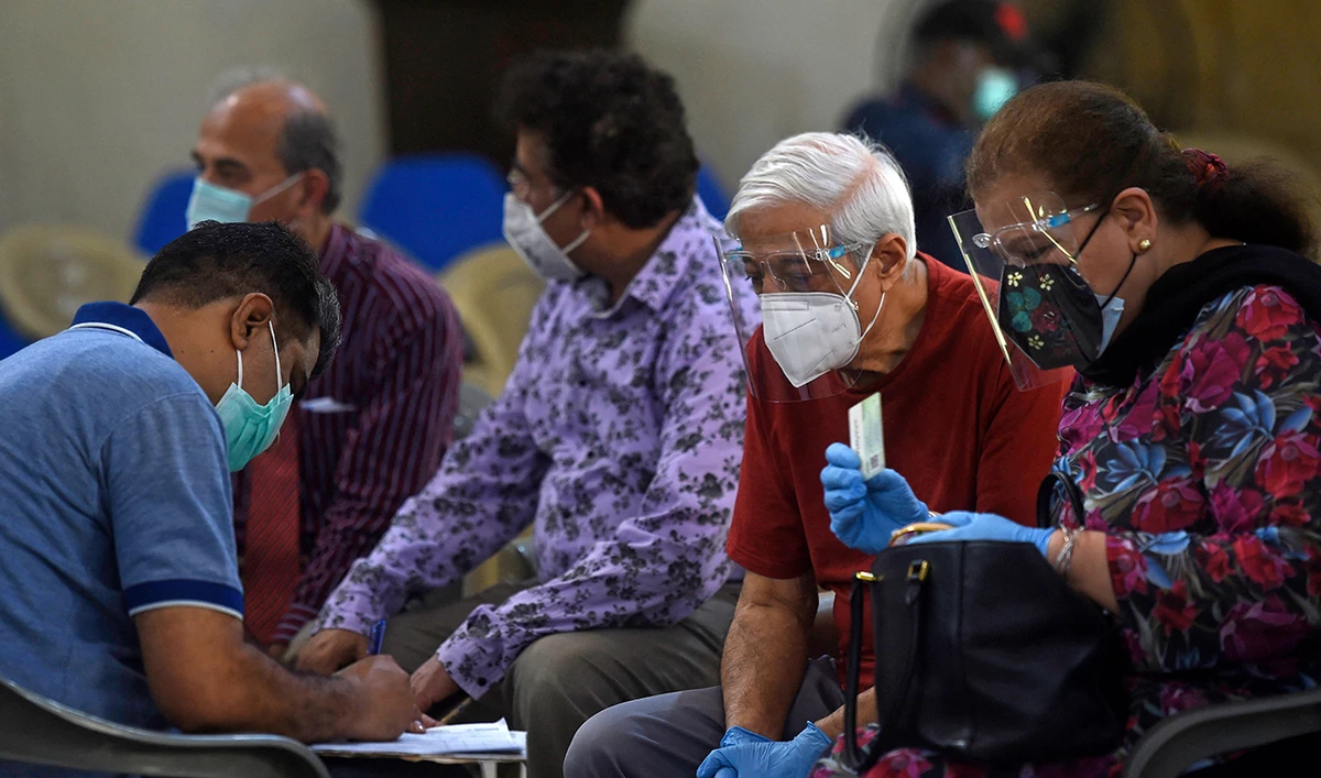 Senior citizens wait to get inoculated with the COVID-19 vaccine in Karachi. (AFP)