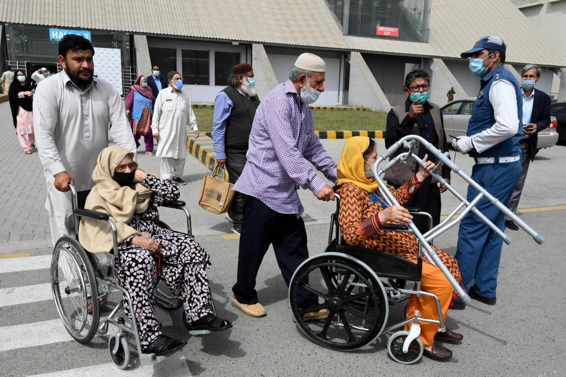 Senior citizens leave after receiving a dose of Sinopharm vaccine at a vaccination centre in Lahore on March 16, 2021. (AFP)