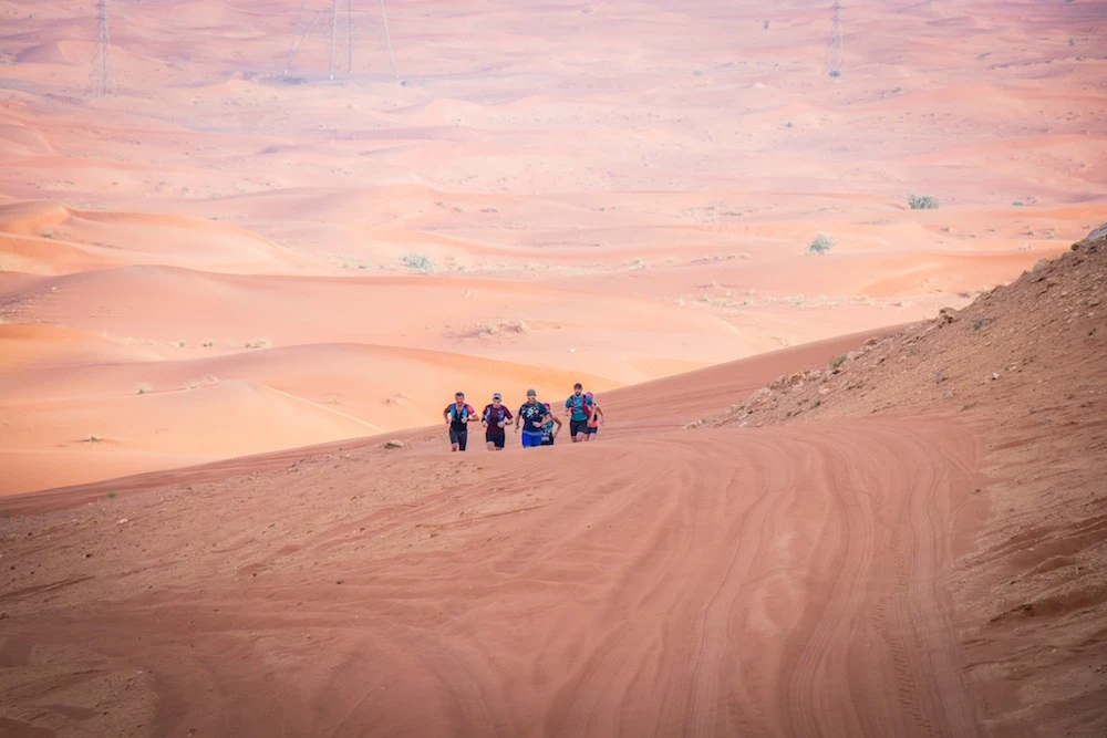 Lee Harris and colleagues tackling the desert terrains of the UAE. (Supplied)