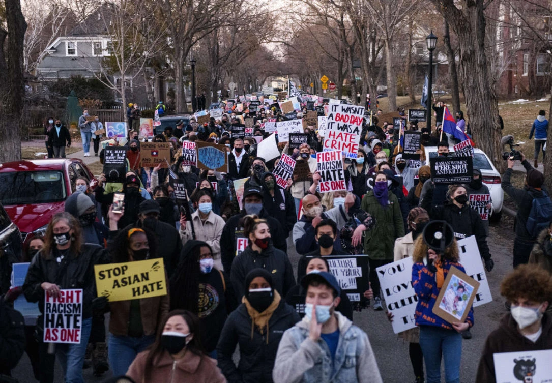 People march through a neighborhood to protest against anti-Asian violence on March 18, 2021 in Minneapolis, Minnesota. (Stephen Maturen/Getty Images/AFP)