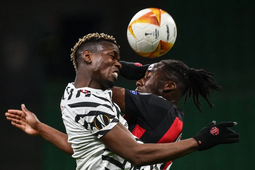 Manchester United’s Paul Pogba, left, and Souhaliho Meite of AC Milan during their Europa League round of 16 second leg match. (AFP)