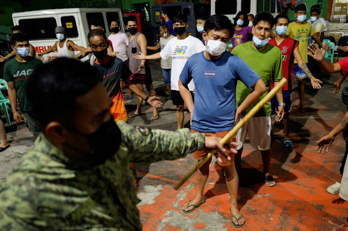 Curfew violators are made to exercise as punishment as the government imposes curfew hours across Metro Manila in response to the surge of the coronavirus disease on March 20, 2021. (Reuters)