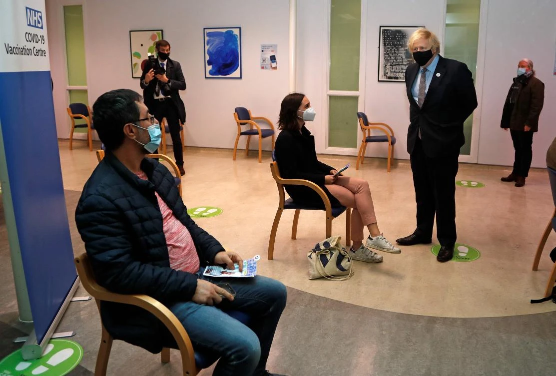 Britain’s Prime Minister Boris Johnson speaks to members of the public after receiving the first dose of the COVID-19 vaccine on March 19, 2021. (AFP)