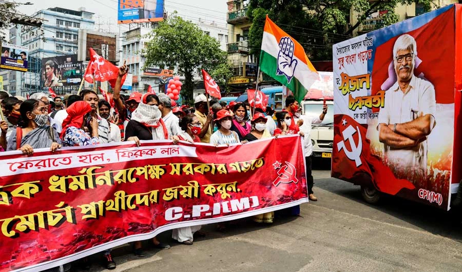 Supporters of Communist Party of India-Marxist (CPI-M)-led Left Front and Congress party walk in a campaign rally for their candidates ahead of the upcoming elections in West Bengal state in Kolkata, India, Saturday, March 20, 2021. (AP)