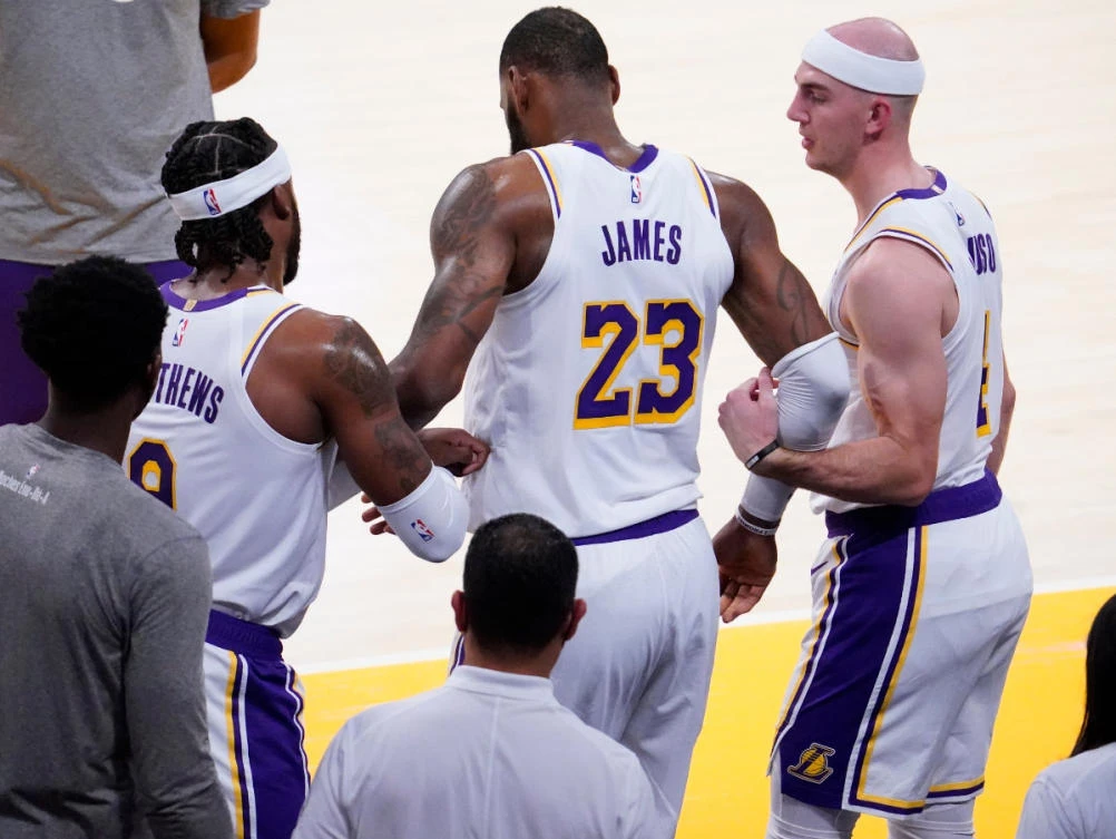 Lakers forward LeBron James is helped up by Wesley Matthews (9) and Alex Caruso (4) after injuring his leg in the second quarter at Staples Center. (Robert Hanashiro-USA TODAY Sports)