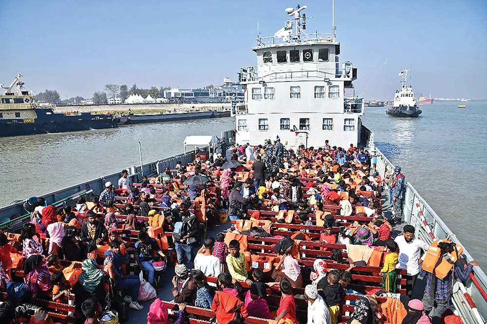 Rohingya refugees sit on a Bangladesh Navy ship in Chittagong as they are relocated to the flood-prone island Bhasan Char in the Bay of Bengal on Dec. 29. (File/AFP)