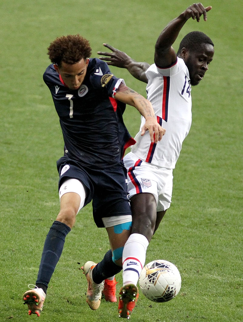 Dominican Republic’s Edarlyn Reyes, left, and Benji Michel of the US during the CONCACAF Olympic qualifying match. (AFP)