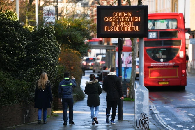 A sign displays public health information amid the spread of COVID-19, London, Britain, Dec. 20, 2020. (Reuters)