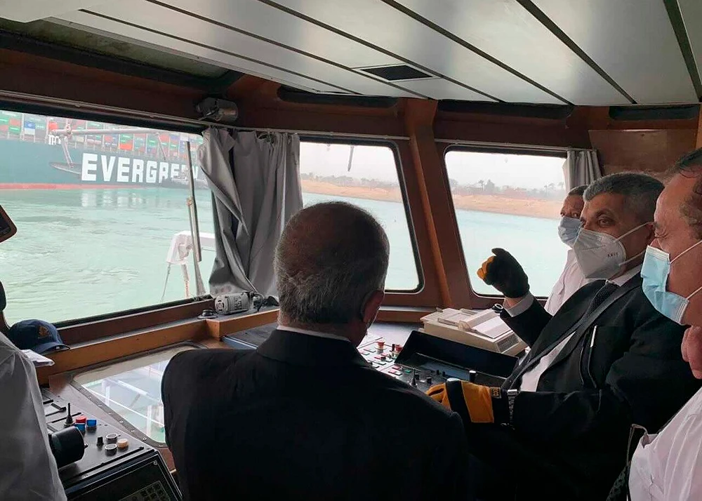 Officials monitor the container ship Ever Green ship which was hit by strong wind and ran aground in Suez Canal, Egypt March 24, 2021. (Suez Canal Authority via Reuters)
