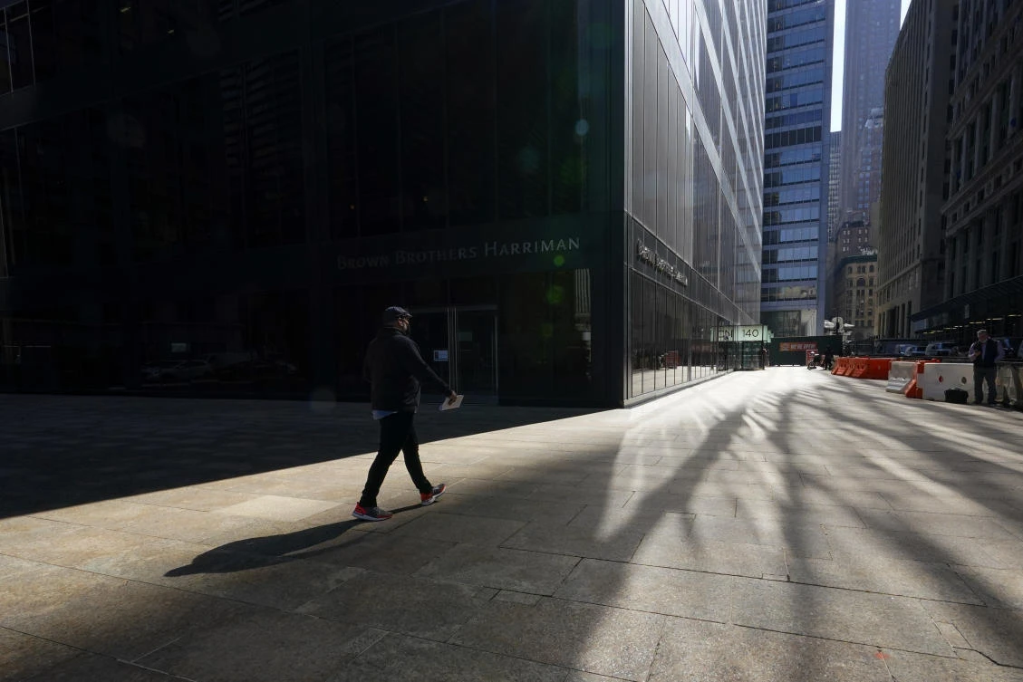 A pedestrian walks on Broadway in New York's Financial District. (AP)